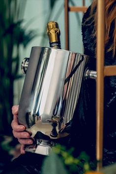 a woman holding a large metal object in her hands