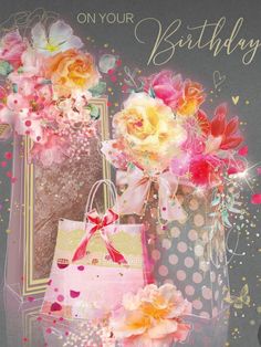 a birthday card with flowers and bags on the front, surrounded by confetti