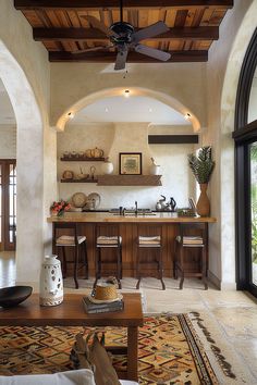 a living room filled with furniture and a ceiling fan