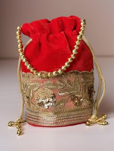 Potli Bag will make you feel incredibly classy in every way! Exquisitely embroidered by hand with glittery metallic threads and genuine semi precious stones. It is certain to bring you compliments. Perfect accessory for Indian wedding! Hand embroidered by third generation master zardozi artisans.  The meticulous embroidery work showcases the artistry and attention to detail put into creating this accessory. Elevate your ensemble with the Elegance Potli Bag - where craftsmanship meets glamour in Formal Embroidered Rectangular Pouch, Formal Rectangular Embroidered Pouch, Luxury Embroidered Festive Bag, Festive Embroidered Rectangular Pouch, Red Shoulder Bag For Festive Gift, Festive Red Shoulder Bag As Gift, Festive Red Shoulder Bag For Gifts, Formal Embroidered Pouch Evening Bag, Luxury Embroidered Festive Bags