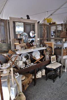 a room filled with lots of old furniture and items in it's display area