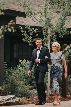 a man and woman in formal wear walking together