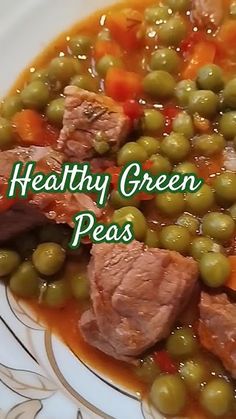 a white plate topped with meat and green peas