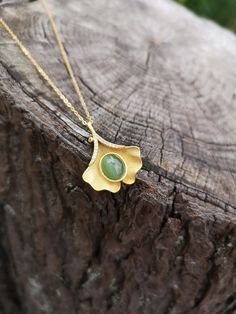 100% Genuine Natural Untreated Siberian Cats eye Nephrite Jade pendant with gold plated 925 silver. Beautiful Green Color, hand crafted.  This beautiful handcrafted necklace designed in a gorgeous leaf style with a modern twist.  It adds a bit of bohemian elegance to your everyday wear or to a special occasion. * Beautiful nephrite cat's eye. Very nicely shaped.  * Rare green nephrite with cat's eye effect, amazing stone, of superior quality.  * Please note that natural precious gemstones may in Jade Cabochon Pendant Necklace, Nature-inspired Jade Pendant Necklace, Handmade Elegant Leaf-shaped Necklace, Unique Yellow Gold Necklace With Cabochon, Nature-inspired Jade Pendant Jewelry, Nature-inspired Gold Jade Jewelry, Handmade Yellow Gold Jade Necklaces, Handmade Yellow Gold Jade Necklace, Nature-inspired Gold Gemstone Necklaces