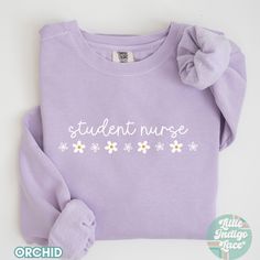 Student Nurse Sweatshirt for the future nurses makes a great gift idea too! Each sweatshirt comes with a relaxed fit, a rolled-forward shoulder, and a back neck patch on the Comfort Colors brand sweatshirts.  ♡Comfort Colors 1566: -80% ring-spun cotton, 20% polyester -Medium-heavy fabric  -Relaxed fit ♡GILDAN 1800 SWEATSHIRT: - 50% cotton, 50% polyester -Loose fit -Sewn-in label -Runs true to size but if you want to an oversized look, size up! ♡ DISCLAIMERS: - Colors may vary depending on the de Relaxed Fit Long Sleeve Nursing Top, Casual Long Sleeve Nursing Tops, Cotton Sweatshirt For Nursing In Fall, Nursing Long Sleeve Relaxed Fit Sweatshirt, Cotton Nursing Sweatshirt For Fall, Long Sleeve Nursing Sweatshirt With Relaxed Fit, Casual Long Sleeve Nursing T-shirt, Cotton Nursing-friendly Relaxed Fit Sweatshirt, Cotton Relaxed Fit Nursing Sweatshirt