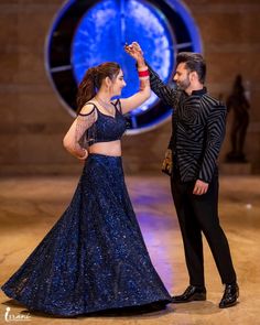 a man and woman dancing on stage