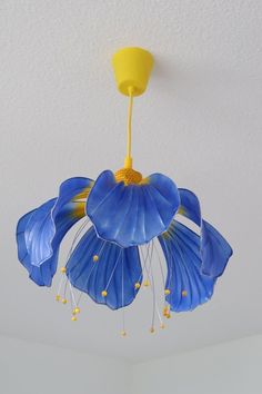 a blue flower is hanging from the ceiling