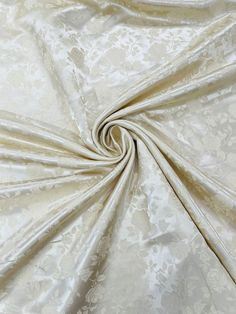 an image of a white fabric that is very soft and shiny with some flowers on it