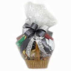 a gift basket filled with assorted chocolates and candies, wrapped in clear cellophane