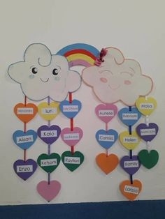 a bulletin board with hearts, clouds and rainbows attached to the back of it