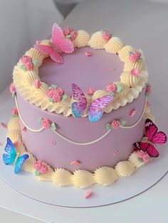 a pink cake with butterflies on it