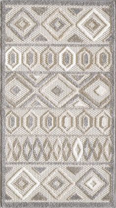 a gray and white rug with an intricate design