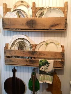 two wooden shelves holding plates and other dishes