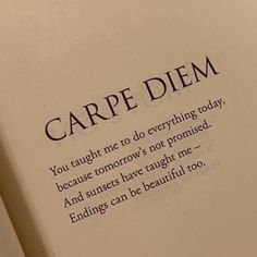 an open book with the words carpe diem written in black ink on it