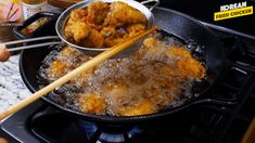 someone is stirring food in a skillet with chopsticks on the stove top