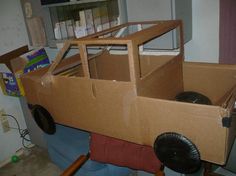 a cardboard car made to look like it's in the process of being built