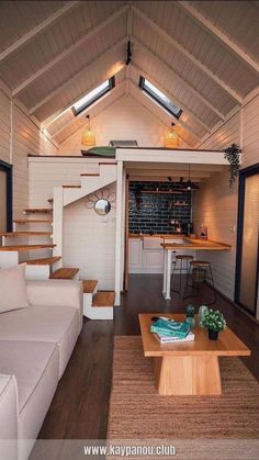 a living room filled with furniture and a wooden table