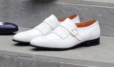 Style: 17007-8831-White Exclusive for C & E Fashions! Completely Handmade, this Matte Calfskin slip-on Loafer from the Ugo Vasare collection by Maurice features Goodyear Welted Construction, a Wingtip Design, Decorative Perforations, a Decorative Kiltie with Strap & Goldtone Buckle, and a full Leather Sole! Classic White Slip-ons With Flat Heel, White Closed Toe Slip-ons For Office, White Almond Toe Slip-ons For Business, Elegant Slip-ons For Spring Galas, White Flat Heel Dress Shoes For Business, Classic White Flat Heel Slip-ons, Classic White Flat-heel Slip-ons, Classic White Almond Toe Slip-ons, Elegant White Leather Slip-ons