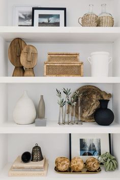 white shelves with pictures, vases and other items