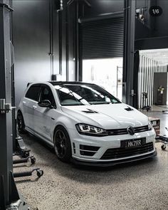 a white car is parked in a garage