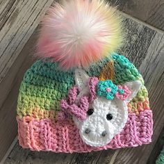 a crocheted hat with a unicorn on it