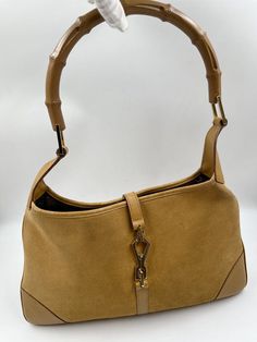 A stunning vintage Gucci Jackie bag made from a super soft suede, featuring gold hardware. and the iconic bamboo handle. Inside the bag is lined with brown cotton lining and there is a zipped pocket for valuables. This bag is in overall good vintage condition with some slight wear to the base edges and some marks to the suede. A true collectors item and the perfect summer bag. Vintage Gucci Jackie, Summer Bag, Bamboo Handles, Timeless Handbag, Diaper Backpack, Casual Backpack, Flap Bag, Baby Bag, Soft Suede