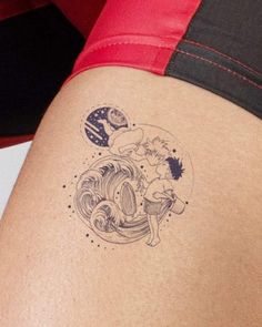 a woman with a tattoo on her thigh