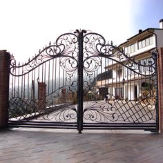 an iron gate in front of a brick building