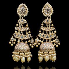 Preserve timeless charm into marvelous ensembles! With an absolute tale of elegance and sophistication, this pair showcases the beautiful composition of thapa kundan and beaded work with contemporary decorative pearl moti details adorned with true craftsmanship. Approximate earrings length is 4.5". Gold-plated on a high-quality brass as base metal. Made by order. Kindly allow 4-6 weeks for the delivery of this item. For custom or urgent requests, please contact support@alacouture.com. *Please No Beautiful Composition, Beaded Work, Faux Stone, Base Metal, Matching Earrings, Statement Necklace, Gold Plate, Composition, Plating