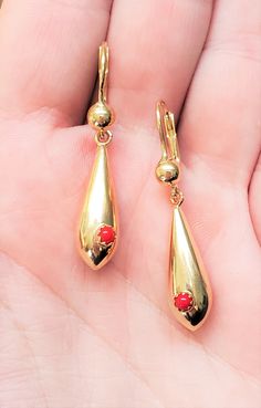 "Vintage drop earrings with Coral stone. Details: Weight: 4.8 grams Style: Dangle Primary Stone: Coral Stone Shape: Round Drop Length: Appx. 1 1/2\" Closure: Lever Back Origin: Italy Metal: 14k Yellow Gold Condition: Previously worn/great condition The back of each earring is stamped with '14k'. All pieces are polished and refinished in our shop. PACKAGING: Each item comes in a jewelry box and wrapped beautifully as a gift. If you would like us to include a gift note in the parcel, please leave