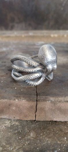 This lovely Octopus ring is perfect for daily wear. It is crafted from fine 925K silver and has the most intricate details that are sure to catch the eye of anyone who sees it.  Handcrafted with love and joy, this ring will be with you for years to come, possibly even taking its place as a family heirloom for generations to come! With its handmade detailed engravings, this silver ring is sure to catch some serious attention and make a beautiful gift for your beloved ones. ITEM DETAILS: Gender : Octopus Ring, Ocean Ring, Silver Mens Ring, Jewelry Ocean, Ring Man, Sea Animal, Ring Men, Mens Silver Rings, Mens Ring