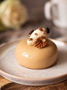 a small dessert with nuts and cream on a plate