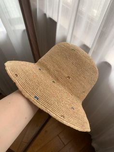 This hat is based on raffia straw, and the overall design is fresh and natural, suitable for daily wear. The hat is made of light straw, which is breathable and suitable for summer use. It is both practical and fashionable. Its wide brim provides good sun protection and can effectively block strong sunlight. At the same time, the edge of the brim has a slight wave feeling, adding a soft temperament. The surface of the hat is dotted with some colorful embroidery patterns, which adds fun and perso Spring Straw Hat In Natural Fiber, Summer Woven Bucket Hat With Short Brim, Brown Woven Jute Straw Hat, Summer Woven Bucket Hat, Casual Short Brim Woven Bucket Hat, Multicolor Bucket Straw Hat For Spring, Casual Handwoven Straw Hat For Summer, Casual Woven Bucket Hat With Short Brim, Casual Handwoven Summer Hats