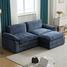 a living room with a blue couch and rug