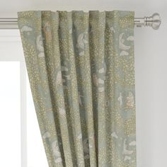 the curtain is hanging in front of a window with birds and leaves on it's valance