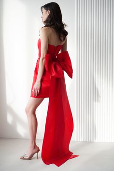 a woman in a red dress posing for the camera