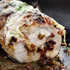 some meat is being cooked in a skillet with sauce and seasoning on it