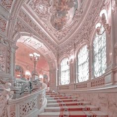 an ornately decorated staircase with red and white carpet