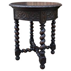 an ornately carved wooden table with turned legs