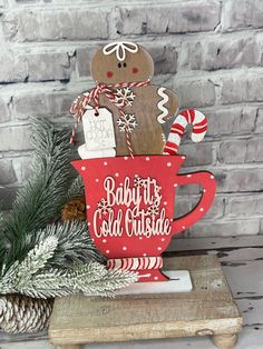 a wooden gingerbread cutout sitting on top of a cup