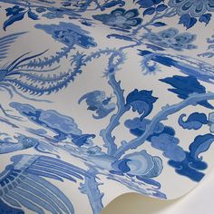 a blue and white wallpaper with an intricate design on it's surface,