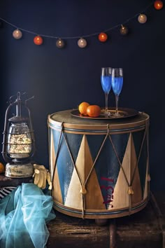 a table topped with two wine glasses next to an orange