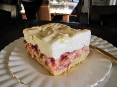 a piece of cake sitting on top of a white plate next to a gold fork