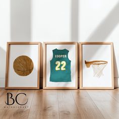 three framed photos of basketball jerseys and a basket ball on the floor in front of a white wall