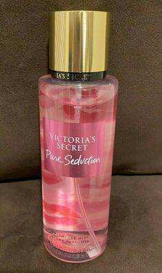 victoria's secret pure solution perfume bottle with gold cap and pink liquid in it