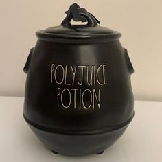 a black pot with writing on it that says polytytuce potterton in gold lettering