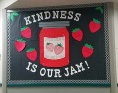 a sign that says kindness is our jam with strawberries on the front and bottom