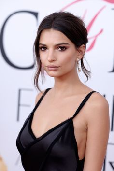 an image of a woman in black dress at the afia awards ceremony, looking to her left