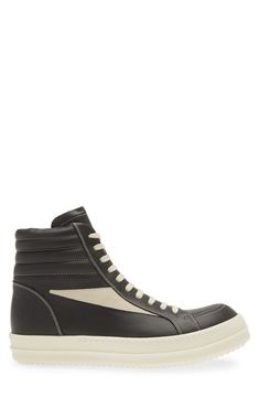 Crafted from full-grain leather and suede, this high-top sneaker is quintessentially Rick Owens with its blunted toe, dramatic lacing and shark-tooth sole. Drawing inspiration from vintage silhouettes and color schemes, this boldly topstitched shoe blends modern comfort with a timeless aesthetic. Lace-up style Leather upper and lining/rubber sole Made in Italy Designer Shoes Modern Calf Leather High-top Sneakers For Streetwear, Lace-up High-top Sneakers In Calf Leather For Streetwear, Lace-up High-top Calf Leather Sneakers For Streetwear, Calf Leather High-top Sneakers With Abzorb Midsole For Streetwear, Sporty High-top Sneakers With Vulcanized Sole In Calf Leather, Calf Leather High-top Sneakers With White Sole For Streetwear, Calf Leather High-top Sneakers For Streetwear, Sporty Calf Leather High-top Sneakers, Designer Calf Leather High-top Sneakers For Streetwear