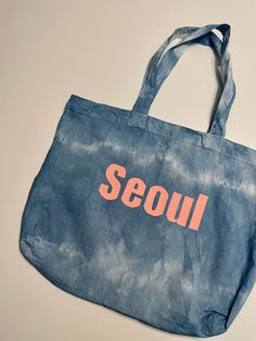 Tote bag, perfect minimalist aesthetic tote bag, great gift idea, eco-friendly bag, reusable tote bag DETAILS A simple tote bag that is SUPER chic and SUPER light. Try a variety of different looks! Three design options- the Vintage, Paris Seoul lines, in a tie-dyed fashion. The Seoul and Vintage Tie-Dyed Totes are the basic staple of any wardrobe.  Fits in with virtually any style.  The designs pictured are some examples of previous creations. These long-handle full-color tote bags are great for all your grab-and-go needs. They feature cross stitching on handles for more stability, and will be a great canvas bag for a greater day! SIZING One size design! MATERIALS - 100% Cotton - One size - Multiple color options - Cross stitching on handles CARE INSTRUCTIONS Machine wash/ Hand Wash Do not Casual Reusable Canvas Bag For Everyday Use, Casual Reusable Bags For On-the-go, Casual Everyday Canvas Bag Reusable, Casual Eco-friendly Canvas Travel Bag, Eco-friendly Ink Canvas Bag For Everyday Summer Use, Casual Everyday Recyclable Bags, Casual Canvas Bag With Eco-friendly Ink For Daily Use, Eco-friendly Canvas Gift Bag For On-the-go, Simple Tote Bag